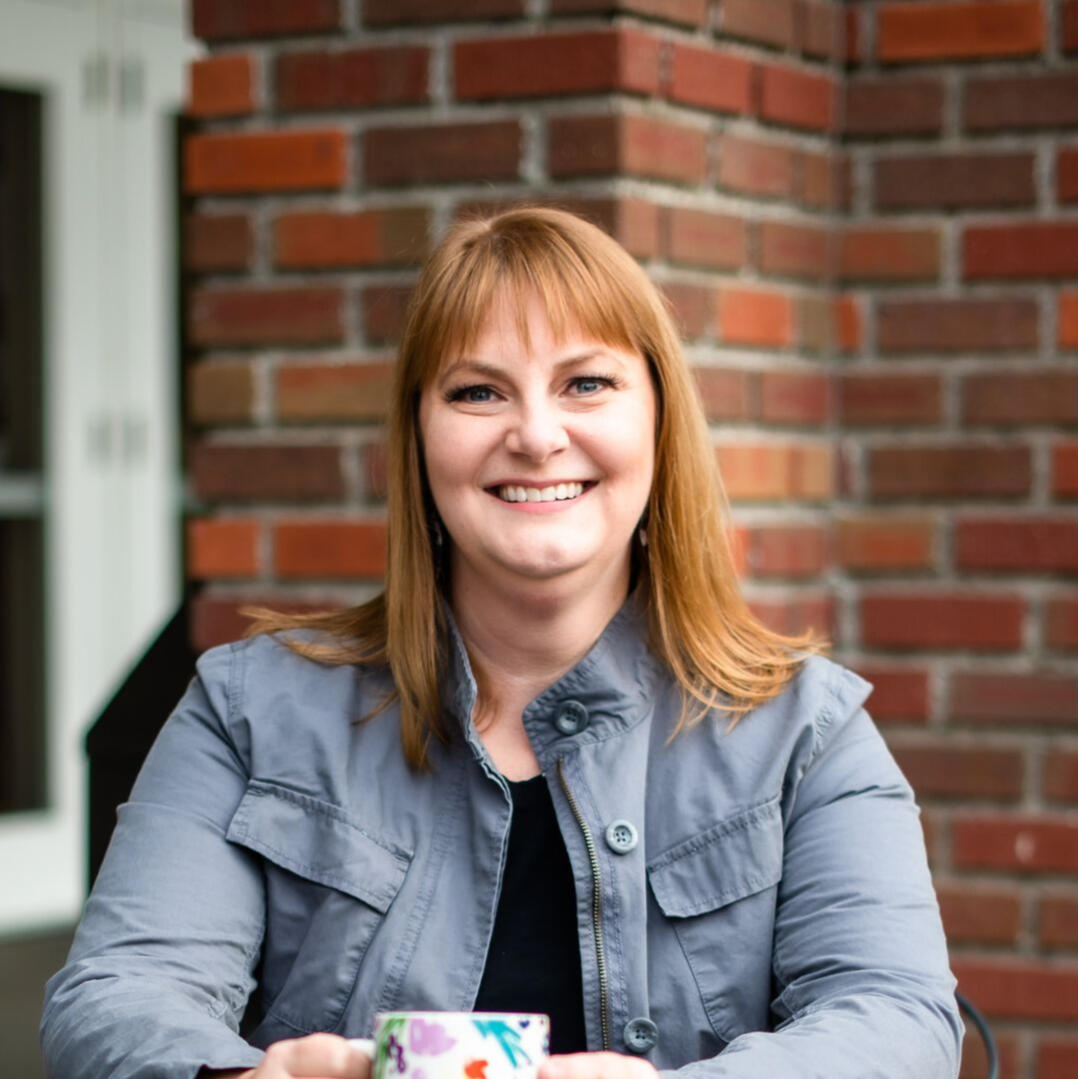 Jennifer Jim, LPC The Relaxed Patient Experience Photo of Jennifer Jim of Renew Therapy NW holding a cup of coffee